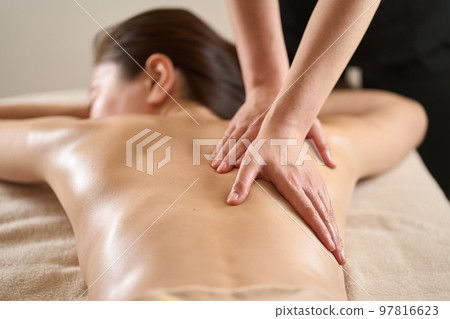 Woman receiving back massage at beauty salon Woman receiving back massage at beauty salon 97816623