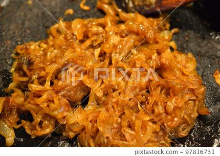 在鑄鐵煎鍋中煎洋蔥,直到它變成棕色。 在鑄鐵煎鍋中煎洋蔥,直到它變成棕色。 97816731