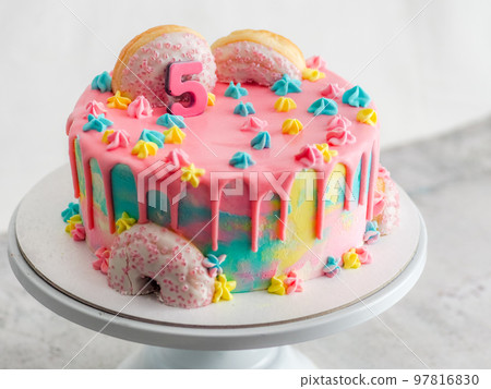 pink 5th anniversary birthday frosted icing dripping cake on white background 97816830