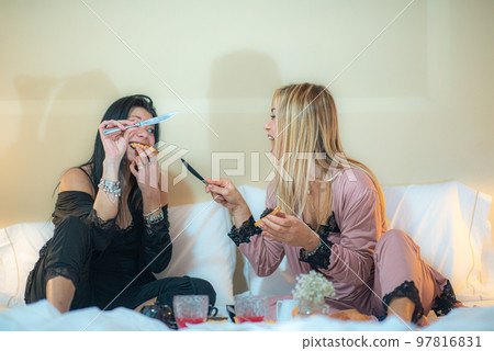 adorable diverse lgbt female couple in bodysuit lying in bed on cream sheets chating after sleeping adorable diverse lgbt female couple in bodysuit lying in bed on cream sheets chating after sleeping 97816831