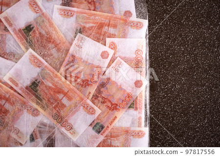Five thousand rubles are thawed in ice. The Russian currency is frozen. Five thousand rubles are thawed in ice. The Russian currency is frozen. 97817556