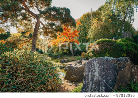 Beautiful Japanese Garden and red trees at autumn seson. A burst of fall color with pond reflections. Beautiful Japanese Garden and red trees at autumn seson. A burst of fall color with pond reflections. 97818056
