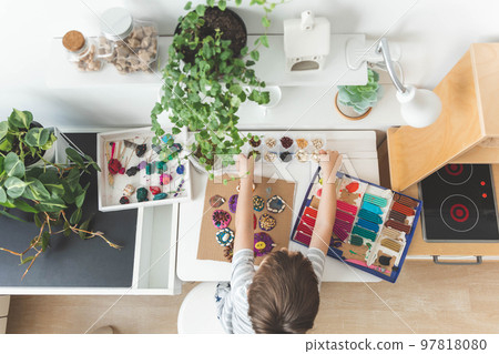 Baby boy creating plasticine diy figure with decorate dried beans element early development top view Baby boy creating plasticine diy figure with decorate dried beans element early development top view 97818080