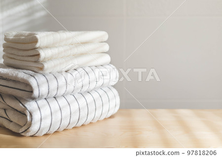 Bath fresh towels pile soft textile cotton body care neatly folded white gray laundry flower shelf 97818206