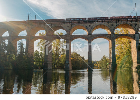 Railway Bridge with river in Bietigheim-Bissingen, Germany. Autumn. Railway viaduct over the Enz River, built in 1853 by Karl von Etzel on a sunny summer day. Bietigheim-Bissingen, Germany. Old Railway Bridge with river in Bietigheim-Bissingen, Germany. Autumn. Railway viaduct over the Enz River, built in 1853 by Karl von Etzel on a sunny summer day. Bietigheim-Bissingen, Germany. Old 97818289