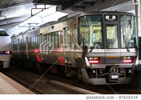 "JR West Japan 223 series train 6000 series" stopping at JR Osaka station "JR West Japan 223 series train 6000 series" stopping at JR Osaka station 97820334