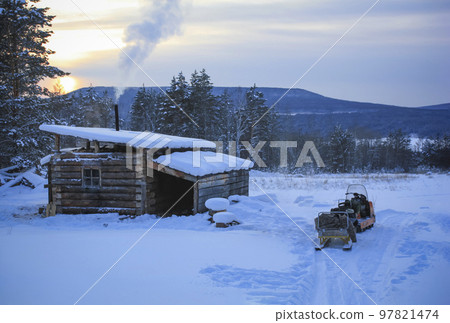 Hunter's hut and snowmobile in winter in the floodplain of the Lena River. Hunter's hut and snowmobile in winter in the floodplain of the Lena River. 97821474