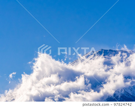 Mt. Fuji in early winter Dynamic clouds covering the foot of the mountain Mt. Fuji in early winter Dynamic clouds covering the foot of the mountain 97824742