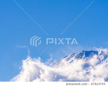 Mt. Fuji in early winter Dynamic clouds covering the foot of the mountain Mt. Fuji in early winter Dynamic clouds covering the foot of the mountain 97824743