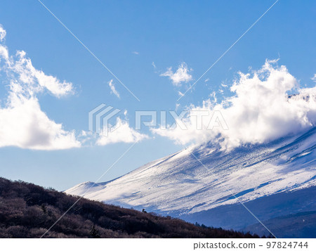 Mt. Fuji in early winter Dynamic clouds covering the foot of the mountain Mt. Fuji in early winter Dynamic clouds covering the foot of the mountain 97824744