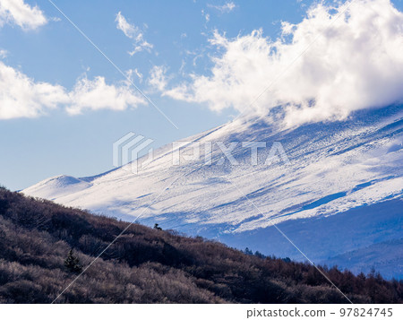 Mt. Fuji in early winter Dynamic clouds covering the foot of the mountain Mt. Fuji in early winter Dynamic clouds covering the foot of the mountain 97824745