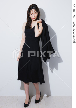 A woman in a black dress 97830127