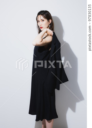 A woman in a black dress A woman in a black dress 97830135