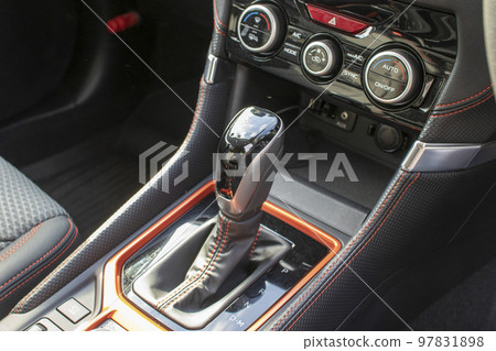 A shift knob that adjusts the gears of an automobile between the driver's and passenger's seats 97831898
