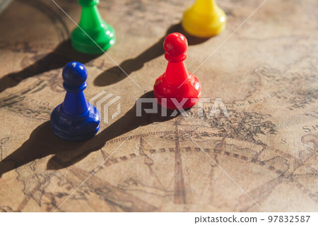 Board game and game chips of different colors on map. 97832587