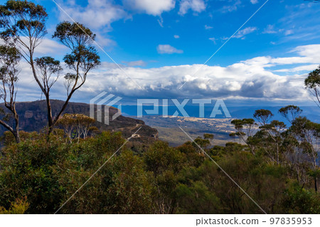 A vast landscape and clouds in the blue sky seen in the Blue Mountains in the suburbs of Sydney 97835953