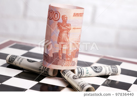 Russian rubles and American dollars on a chessboard Russian rubles and American dollars on a chessboard 97836440