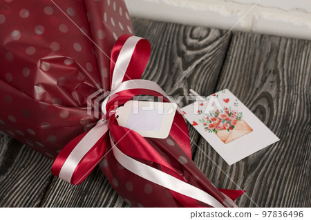 Elements of marshmallow bouquet. Ribbons and company labels. Packed in paper in the form of a bouquet. Close-up. Elements of marshmallow bouquet. Ribbons and company labels. Packed in paper in the form of a bouquet. Close-up. 97836496