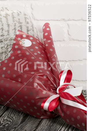Elements of marshmallow bouquet. Ribbons and company labels. Packed in paper in the form of a bouquet. Close-up. Elements of marshmallow bouquet. Ribbons and company labels. Packed in paper in the form of a bouquet. Close-up. 97836522