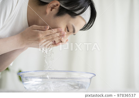 Young men washing face 97836537
