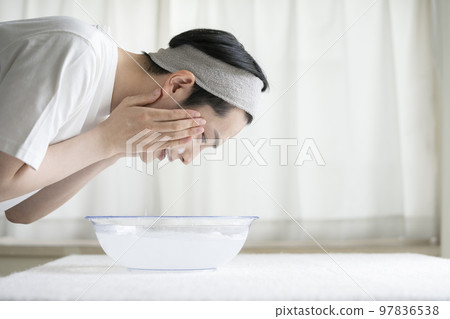 Young men washing face 97836538