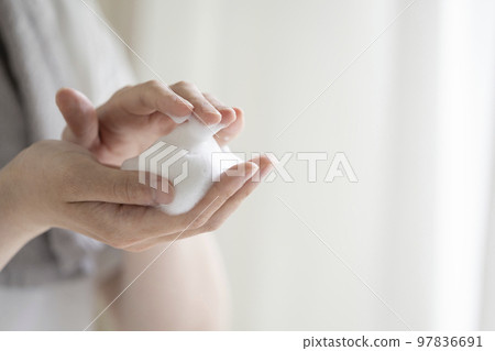 A young man's hand with a foamed face wash A young man's hand with a foamed face wash 97836691