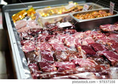 Beef, veal, lamb fresh raw steaks are packaged in vacuum and sold on counter of store. Beef, veal, lamb fresh raw steaks are packaged in vacuum and sold on counter of store. 97837108