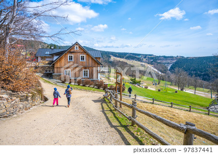 Two young girls going to the mountain house on sunny spring day, U capa, Prichovice, Czech Republic 97837441