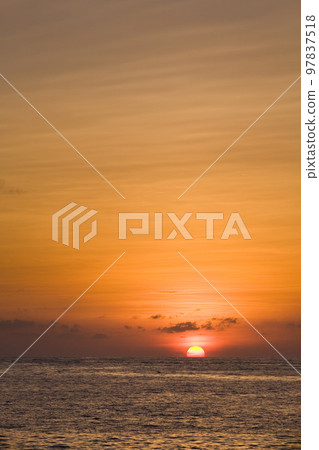 Colorful and beautiful sunset reflected into the ocean Colorful and beautiful sunset reflected into the ocean 97837518