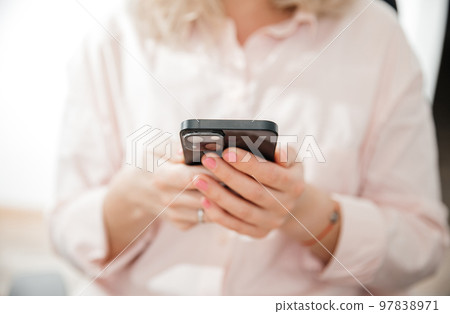 Close up hand of woman using smartphone, work and communication concept, home office Close up hand of woman using smartphone, work and communication concept, home office 97838971