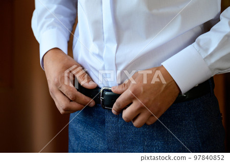 The morning of the groom, the groom prepares for the wedding ceremony, dresses in a suit and shoes. The morning of the groom, the groom prepares for the wedding ceremony, dresses in a suit and shoes. 97840852