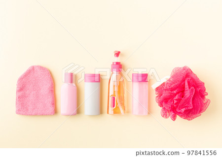 Set of small pink cosmetics bottles for travel or hotel 97841556