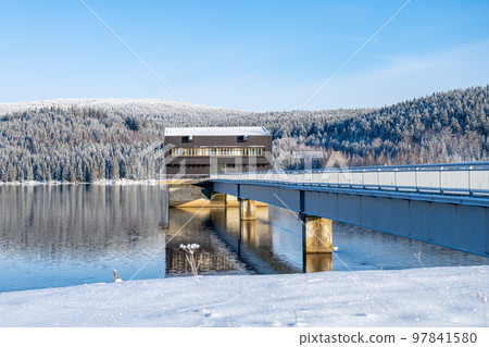 Intake tower of Josefuv Dul Dam and access bridge on sunny winter day, Czech Republic Intake tower of Josefuv Dul Dam and access bridge on sunny winter day, Czech Republic 97841580