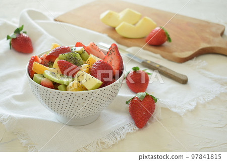 Bowl of fresh fruit salad, kiwi, apples, oranges 97841815