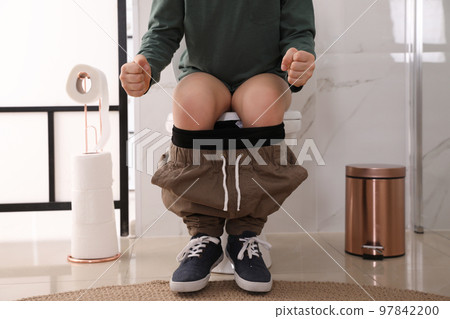 Boy suffering from hemorrhoid on toilet bowl in rest room, closeup Boy suffering from hemorrhoid on toilet bowl in rest room, closeup 97842200