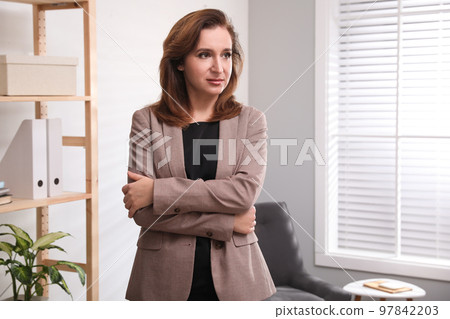 Portrait of woman in light modern office 97842203