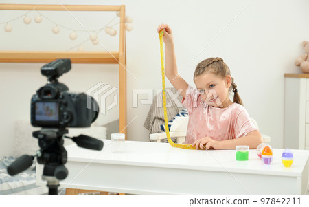Cute little blogger with slime recording video at home 97842211