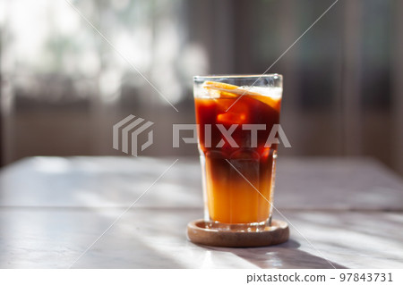 Glass of americano mixed with orange juice Glass of americano mixed with orange juice 97843731