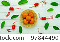 Chinese language mean rich or wealthy and happy.Top view aerial image decoration Chinese new year  lunar new year holiday background concept.Flat lay red orange with blossom on modern  white table. 97844490