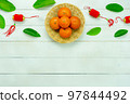 Chinese language mean rich or wealthy and happy.Top view aerial image decoration Chinese new year  lunar new year holiday background concept.Flat lay red orange with blossom on modern  white table. 97844492