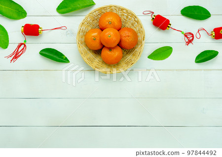 Chinese language mean rich or wealthy and happy.Top view aerial image decoration Chinese new year  lunar new year holiday background concept.Flat lay red orange with blossom on modern  white table. 97844492