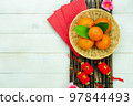 Chinese language mean rich or wealthy and happy.Top view aerial image decoration Chinese new year  lunar new year holiday background concept.Flat lay red orange with blossom on modern  white table. 97844493