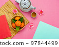 Chinese language mean rich or wealthy and happy.Top view aerial image decoration Chinese new year  lunar new year holiday background concept.Flat lay red orange with blossom on modern  paper. 97844499