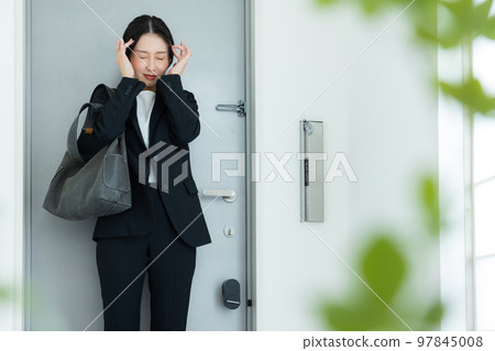 A woman in a suit at the entrance A woman in a suit at the entrance 97845008