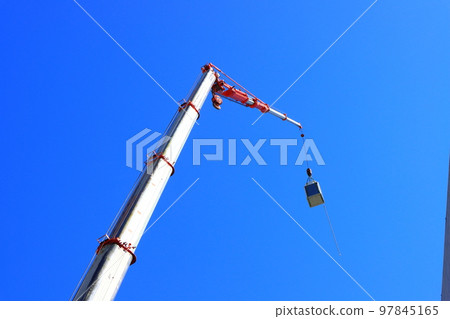 Scenery of a crane truck working at a construction site Scenery of a crane truck working at a construction site 97845165