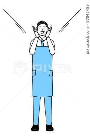 A senior man wearing an apron who calls with his hand on his mouth A senior man wearing an apron who calls with his hand on his mouth 97845489