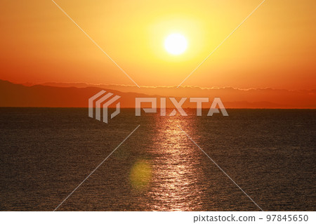 sun setting into the sea 97845650