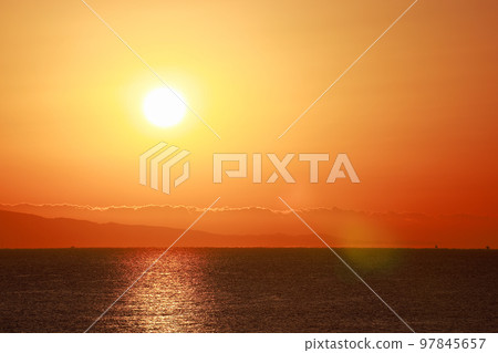 sun setting into the sea 97845657