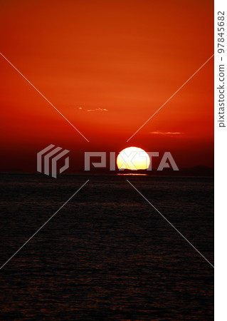 sun setting into the sea 97845682