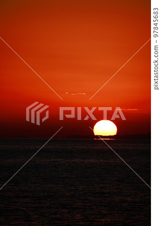 sun setting into the sea 97845683